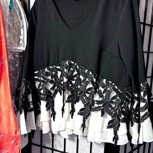 Blk/Wht  Elegantly Framed over A double row of Ruffles.Pair with Stretch Pants